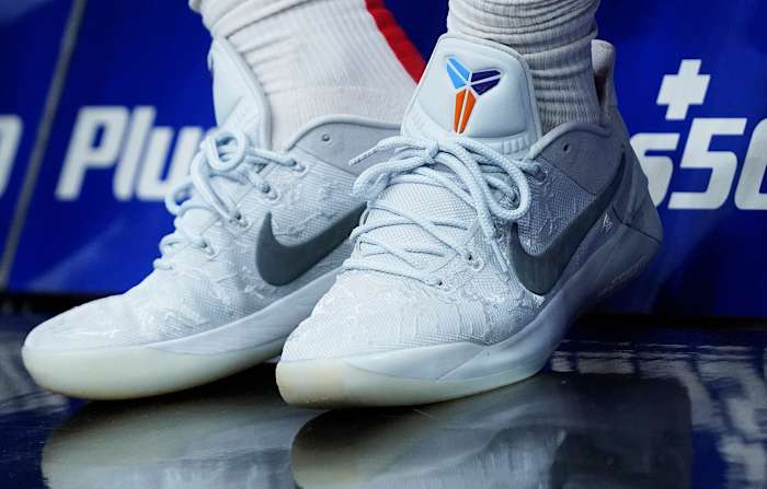 View of white and grey Nike Kobe shoes.